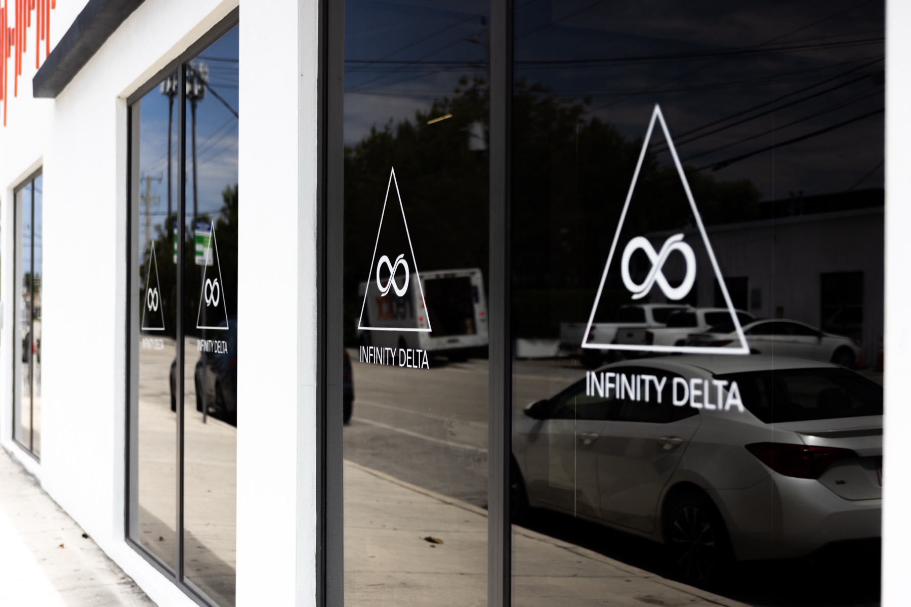 The Infinity Delta storefront with the logo displayed across the front windows.