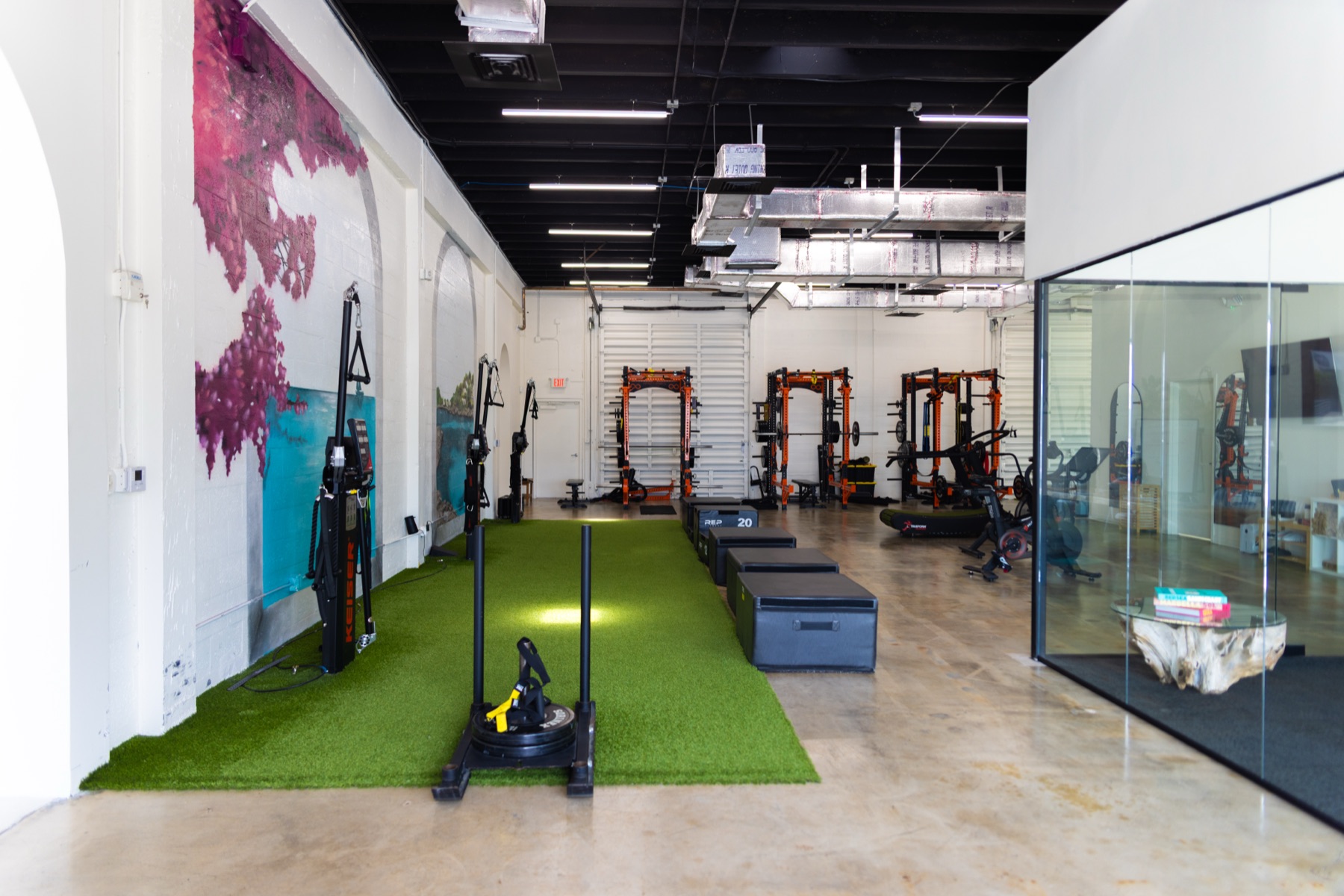 The Infinity Delta training floor with turf, recovery equipment, and open space.