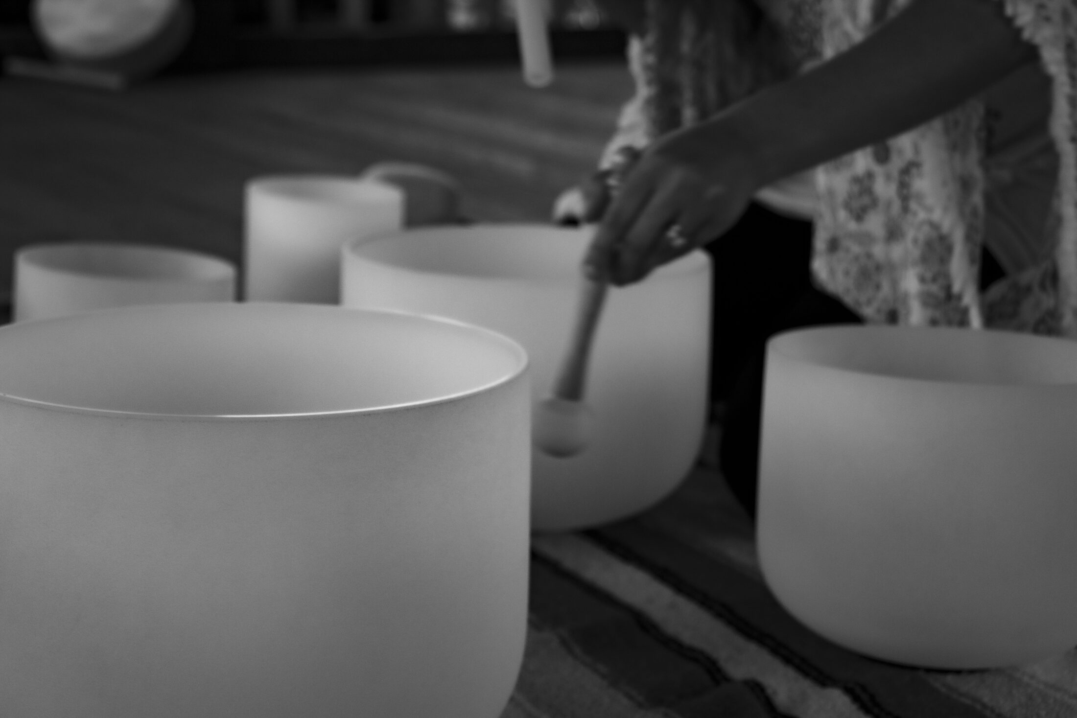 Crystal singing bowls set out during a sound healing session.