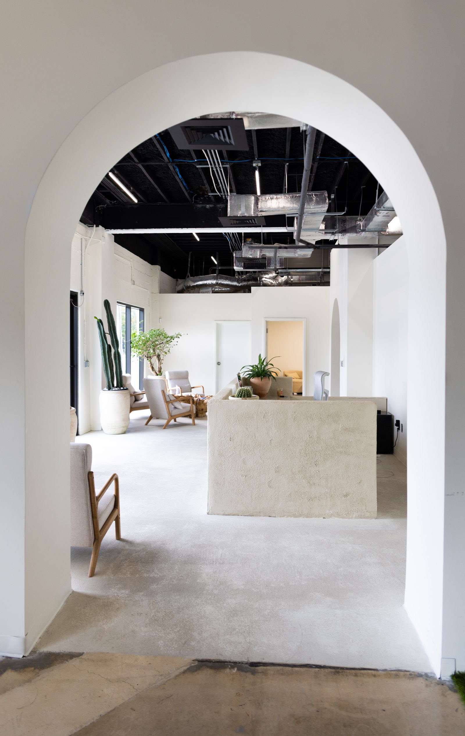 Arched doorway leading into the Infinity Delta reception lounge in Miami.