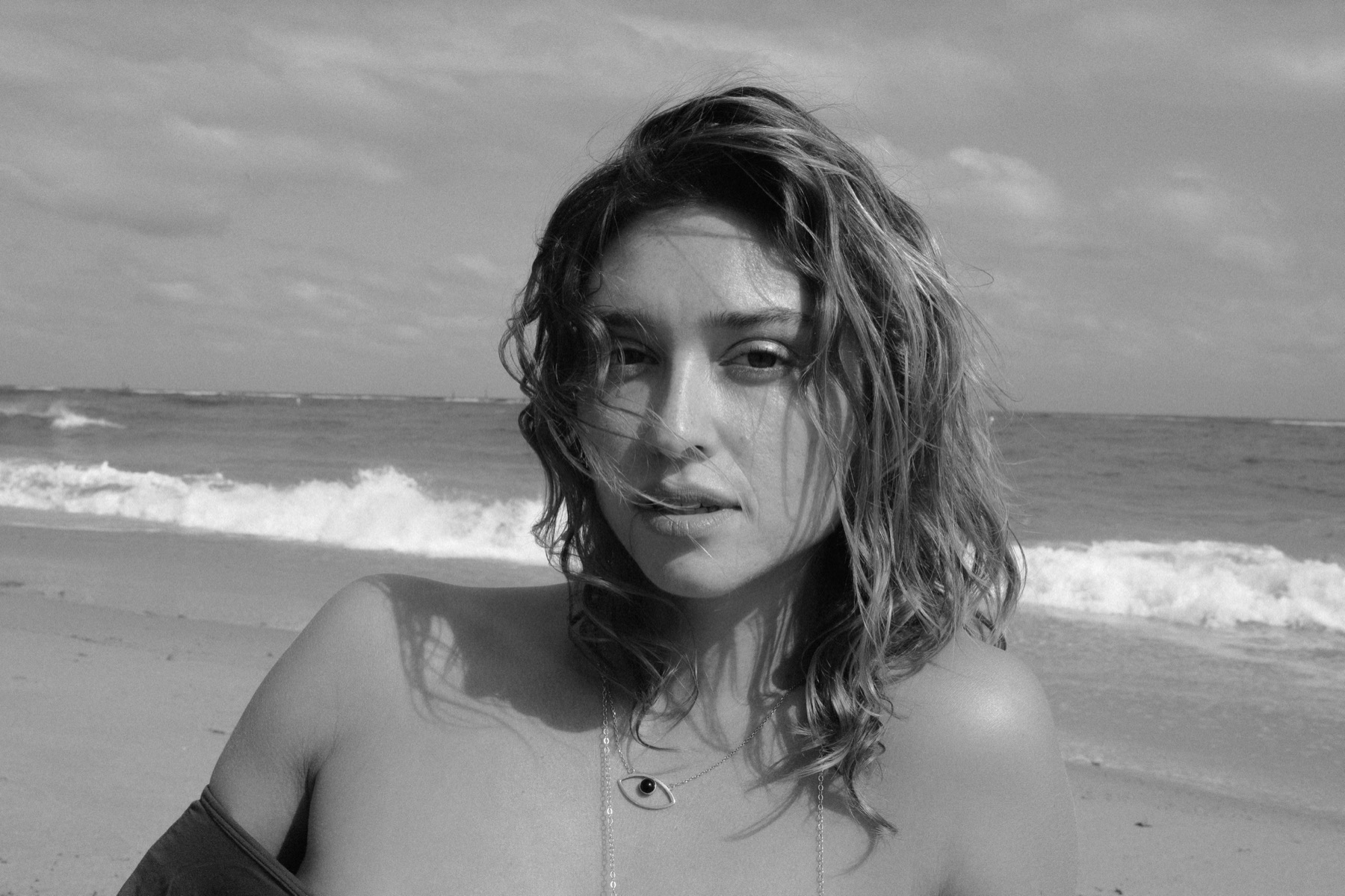 Riley Rich at the beach, framed against the ocean.